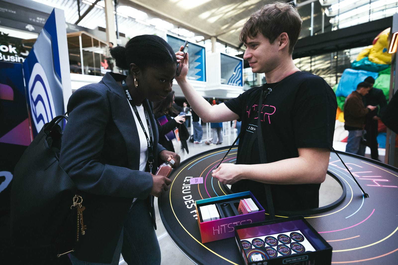 Attendees trying out the Hitster game at the booth