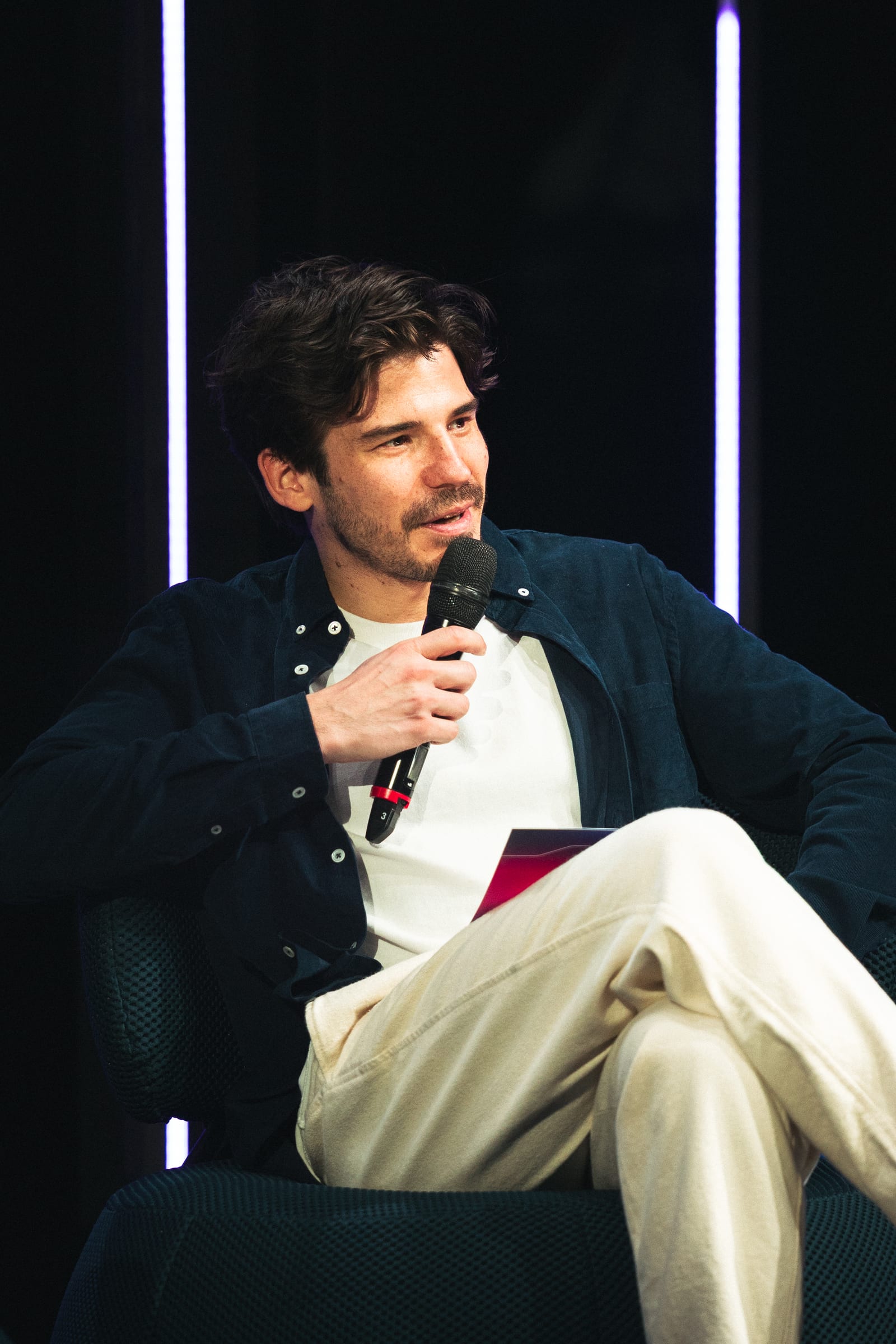 Fireside chat on stage between two LED columns