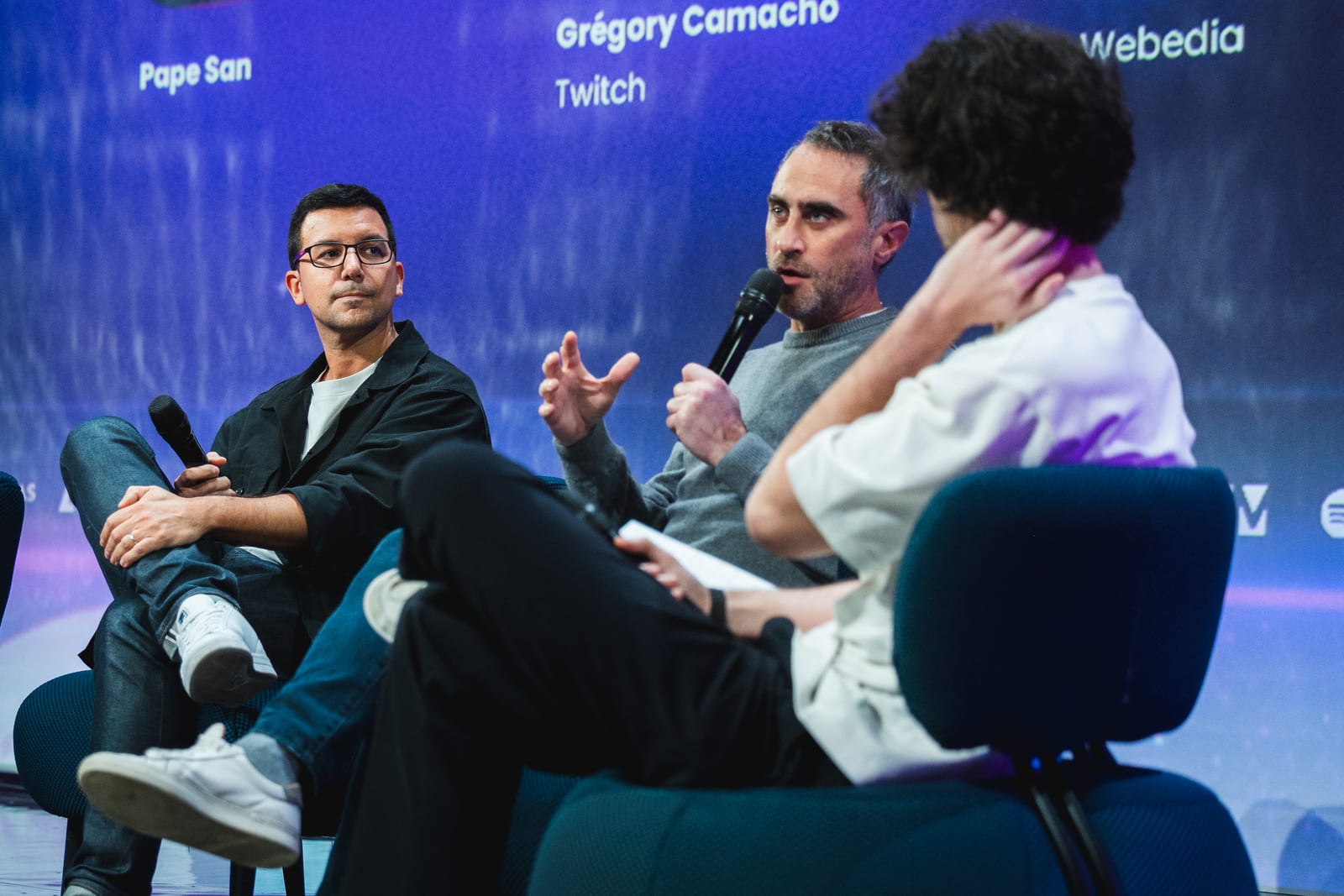 Panel on stage - Twitch, Webedia and Pape San (purple lighting)